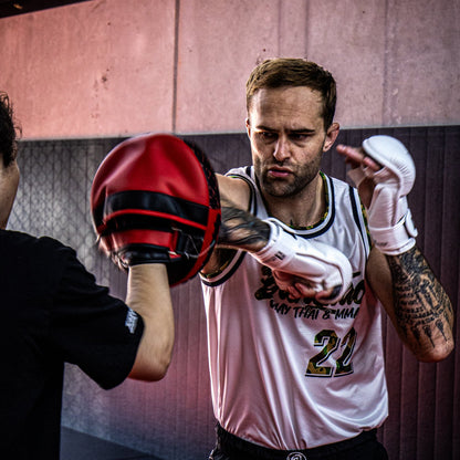 Person practicing MMA with a focus on technique and form.